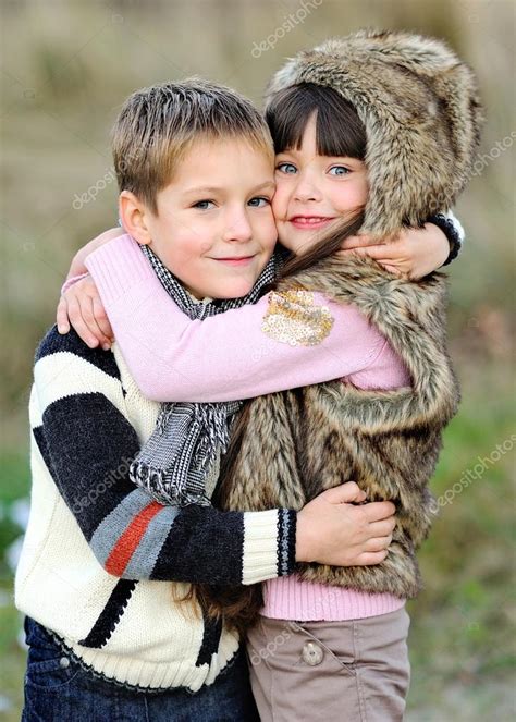 Portrait Of Little Boy And Girl Outdoors In Autumn Stock Photo By