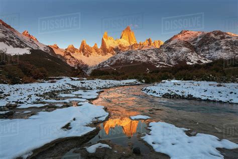 Mountain Range With Cerro Fitz Roy At Sunrise Reflected In River Los