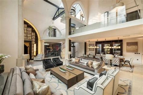 A Large Living Room Filled With Furniture And High Ceilings