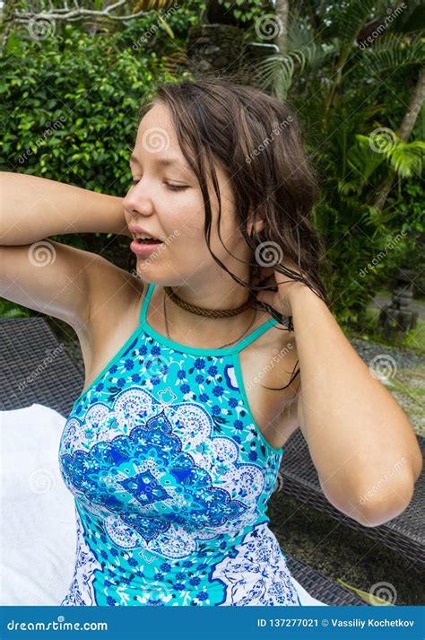 Beautiful Brunette Girl In Blue Swimsuit Posing In Tropical Location