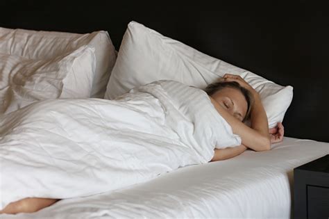 Young Woman Carefree Sleeping In Bed Stock Photo Download Image Now