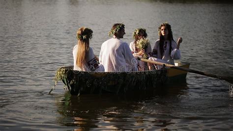 Three Girls And A Guy In The Slavic National Dress Floating In A Boat