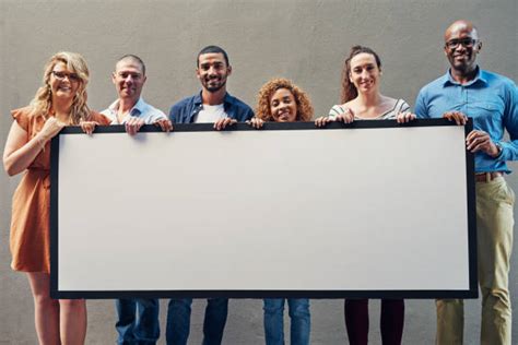Group Holding Sign Stock Photos Pictures And Royalty Free Images Istock