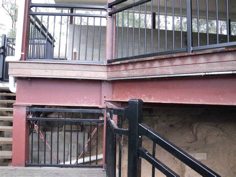 Fenced outdoor storage area below bleachers. Pool Fence Safety Inspections - AWEBBCO