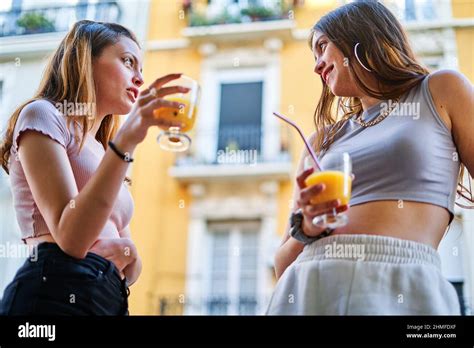 Two Female Friends Drinking At An Outdoor Party Stock Photo Alamy