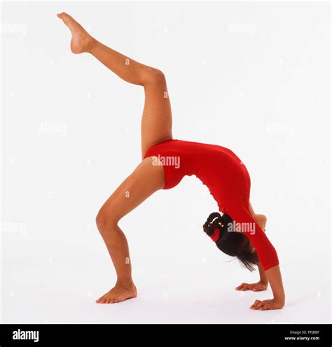 Girl In Red Leotard Bending Over Backwards One Leg In Air Stock Photo