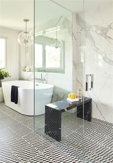 A marble tiled shower bench is positioned beneath a marble tiled niche lined. 7 Shower Bench Ideas to Make Your Bathroom Positively Spa ...