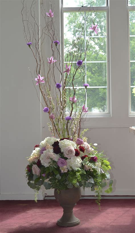 Whimsical, woodland ceremony arrangement of hydrangea, dollar