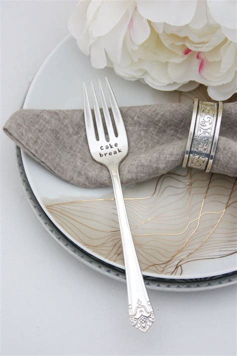 Two Silver Forks On A Plate Next To A Flower