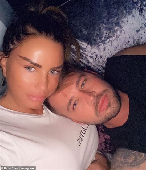 katie price shows off her taut midriff in a white crop top and tracksuit bottoms