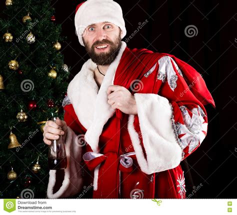 Bad Brutal Santa Claus Carries A Bag Smiling Spitefully And Drinking