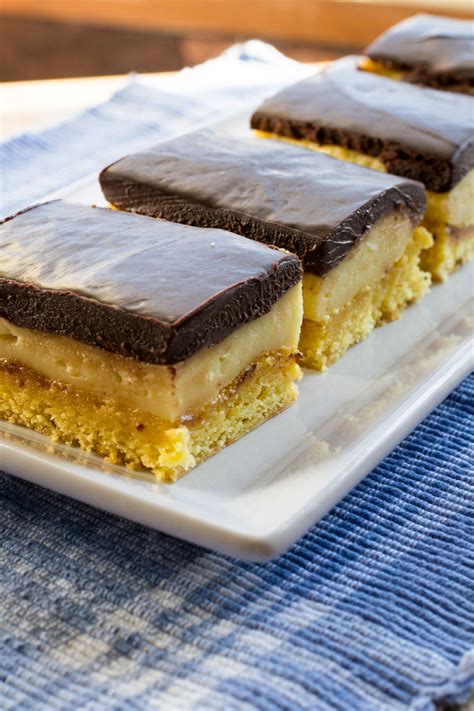 How can you go wrong when moist vanilla cake is filled with vanilla custard cream and topped with a bittersweet chocolate glaze? Boston Cream Bars - What the Forks for Dinner?