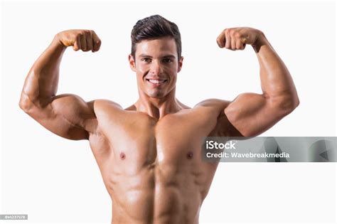 Portrait Of A Muscular Young Man Flexing Muscles Stock Photo Download