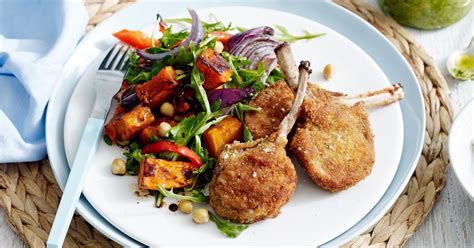 Lamb cutlets and couscous salad. Crumbed lamb cutlets with pumpkin salad and pesto
