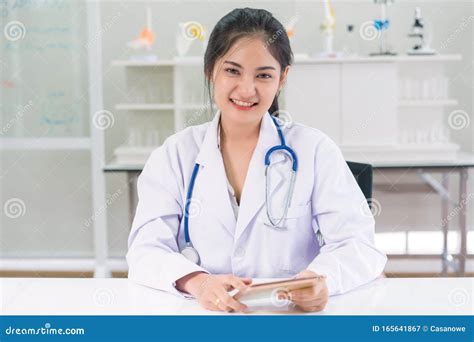 Beautiful Female Doctor At Medical Office Wearing Stethoscope And Lab