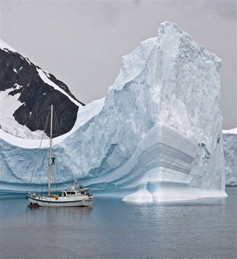 A Yacht Sails Past An Iceberg In Errera Channel Antartica August