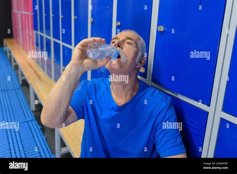 Man Drinking Water In Locker Room Stock Photo Alamy