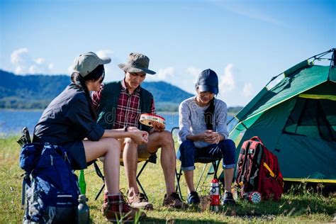 Camping Camp In Nature Happy Friends Sitting Discuss Together In Stock