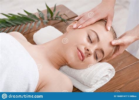 Female Hands Do Rejuvenating Face Massage For Woman On Table With Palm Leaf Stock Image Image