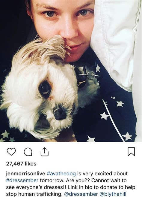 A Woman Holding A Small White Dog In Her Lap And Looking At The Camera