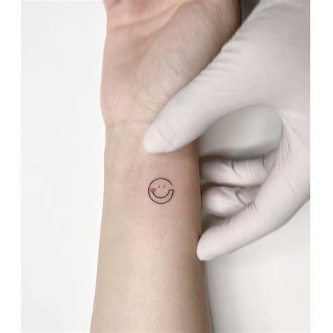 Minimalistic Smiley Face Tattoo Located On The Wrist