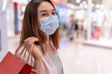 Premium Photo Young Asian Woman Wearing Surgical Mask Shopping In Clothes Store At Mall