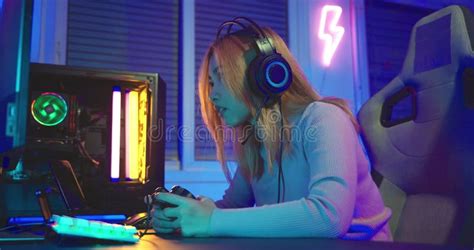 Angry Asian Gamer Wearing Gaming Headphones Playing Joystick Console