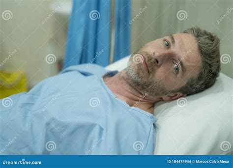 Attractive Injured Man Lying On Hospital Bed Receiving Treatment