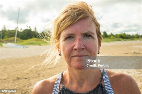 Portrait Of A Pretty Woman In Her Fifties On A Beach Stock Photo