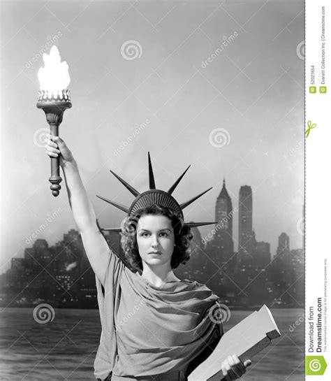 Young Woman Dressed As The Statue Of Liberty With Skyscrapers In The