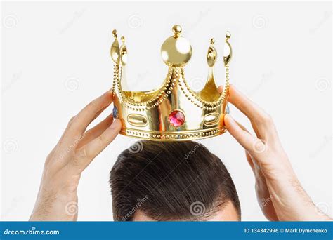 Man On A White Background Wears A Crown On His Head In A Photo Studio