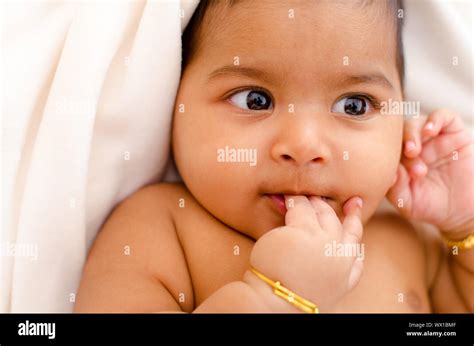 Six Months Old Indian Baby Girl Sucking Her Fingers Stock Photo Alamy