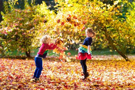 Kids Play In Autumn Park Children In Fall Stock Image Image Of Jump