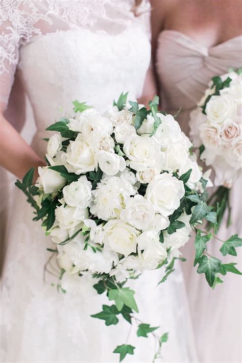 Traditional cascading bouquet of all white flowers including roses