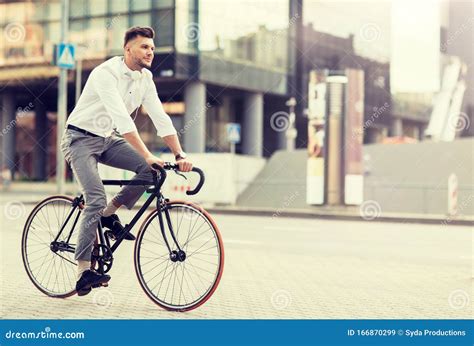 man with headphones riding bicycle on city street stock image image of downtown lifestyle
