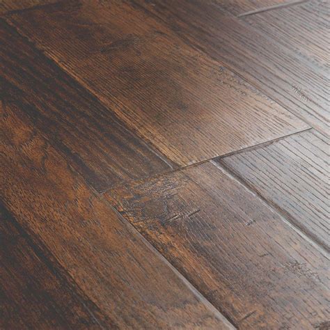 The commercial for this flooring shows a family in the kitchen having a water fight with the faucet and a great dane dog and its says worry. Pergo Outlast+ Somerton Auburn Hickory 10mm Thick x 7-1/2 in. Wide x 47-1/4 in. Length Laminate ...