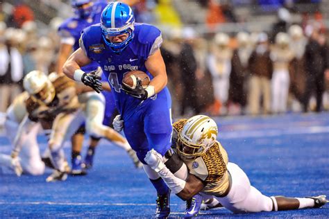 Falcons Shayne Davern breaks away from the Bronco’s defense during the