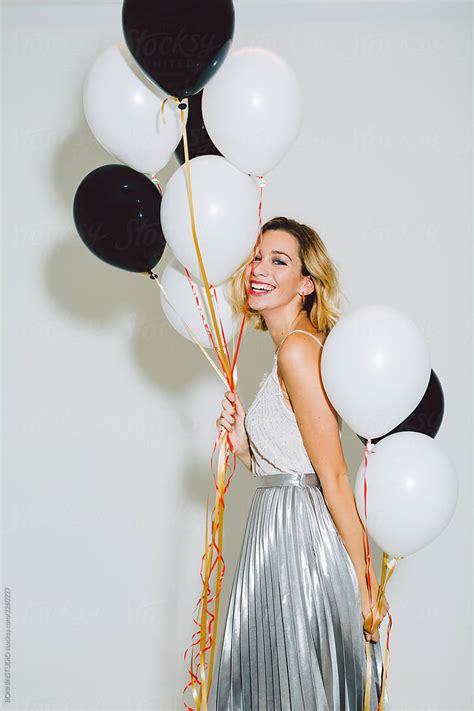 Smiling Beautiful Woman Holding Balloons In A New Year Party Celebration By Stocksy
