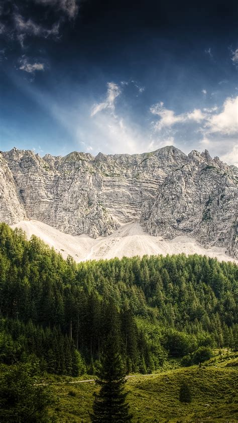 Landscape View Of Rock Mountains Green Trees Slope Grass Field In White