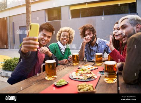 Group Of Multiracial Friends Taking Smiling Selfie With Smartphone People Having Fun Outdoors