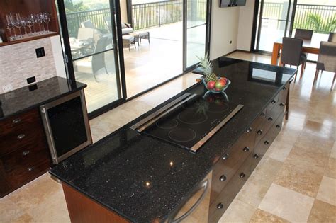 Ge profile series 30 downdraft electric cooktop black glass with stainless steel trim pp9830sjss. The island features a 36 inch induction cooktop and a ...