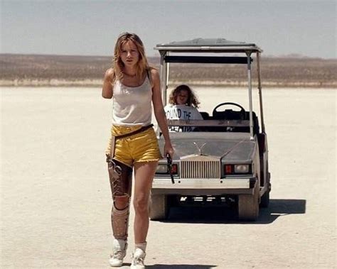 Two Women Walking In Front Of A Golf Cart On The Desert With One Woman Wearing Knee Pads