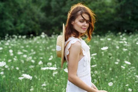 Woman In White Dress In A Field Walk Flowers Vintage Nature Stock Image