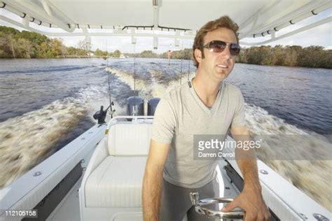 Casual Portrait Of Dustin Johnson Driving Boat During Photo Shoot On