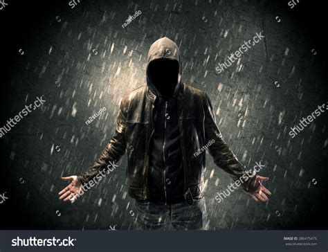 A Faceless Misterious Man In Hoodie And Leather Jacket Standing In The Dark With A Visible