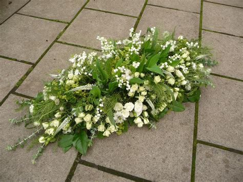 Funeral flowers and sympathy flowers are both designed for that reason. Coffin Tribute with Lily of the Valley, Veronica, Roses ...