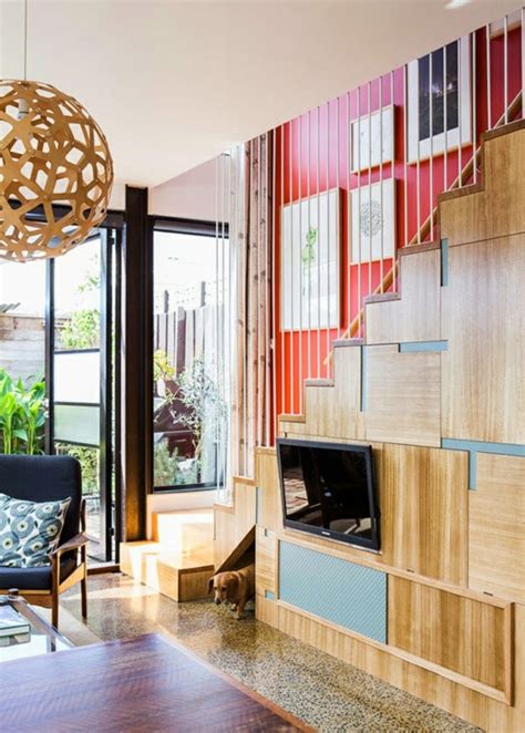 An area rug and cozy armchair create a space you can lounge in as well. 15 Unusual Under stairs storage ideas and solutions
