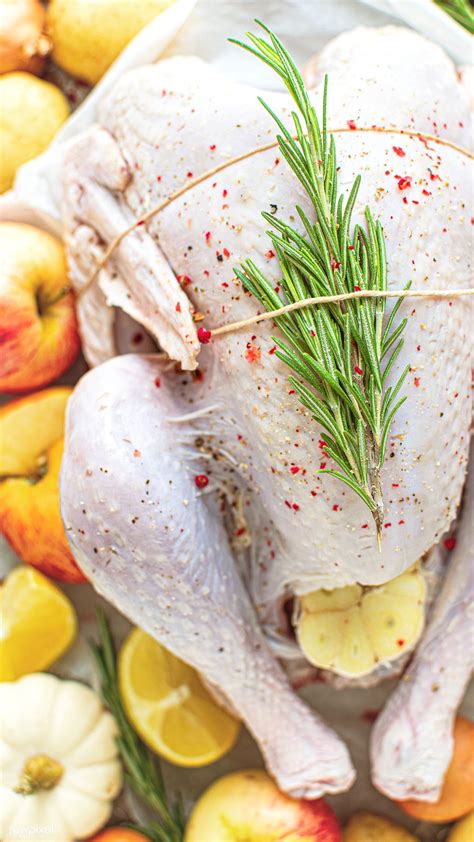 Thanksgiving turkey with spices and vegetables on the wooden table. Download premium photo of Raw turkey with fresh rosemary ...