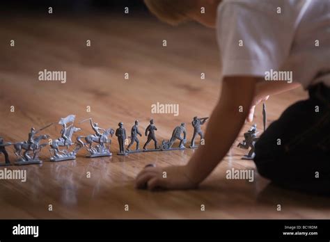 Boy Playing With Toy Soldiers On Floor Stock Photo Alamy