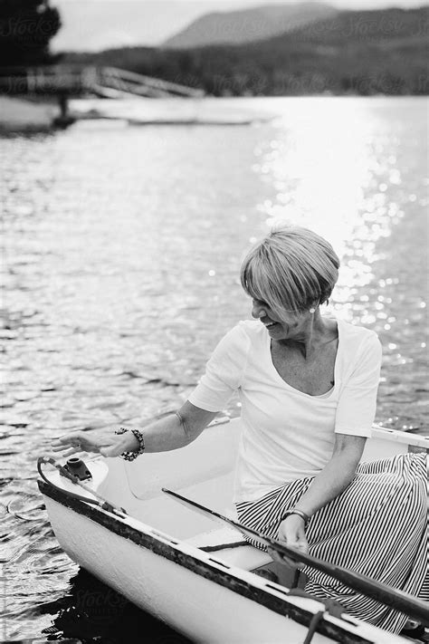 Mature Woman Sitting In Row Boat By Stocksy Contributor Rob And Julia Campbell Stocksy